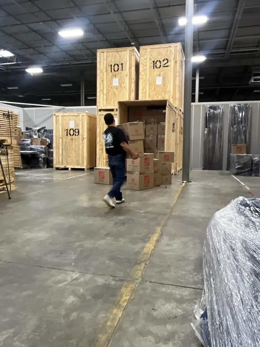 All Dry crew member loading a customer’s belongings into a numbered storage vault