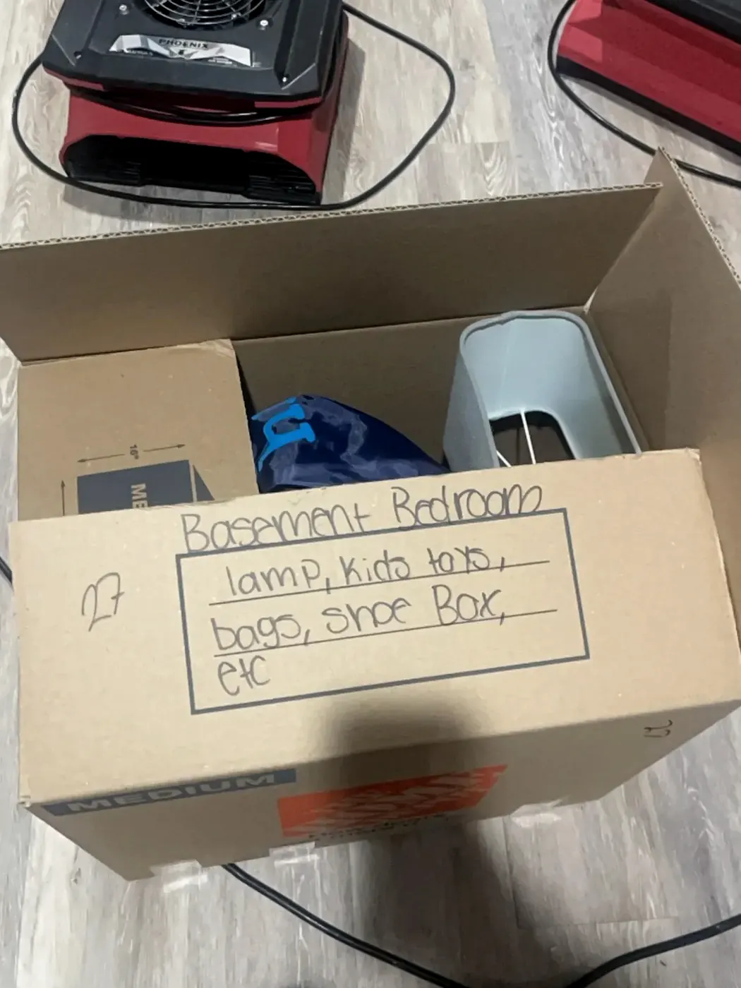 Labeled and inventoried pack-out box next to drying equipment