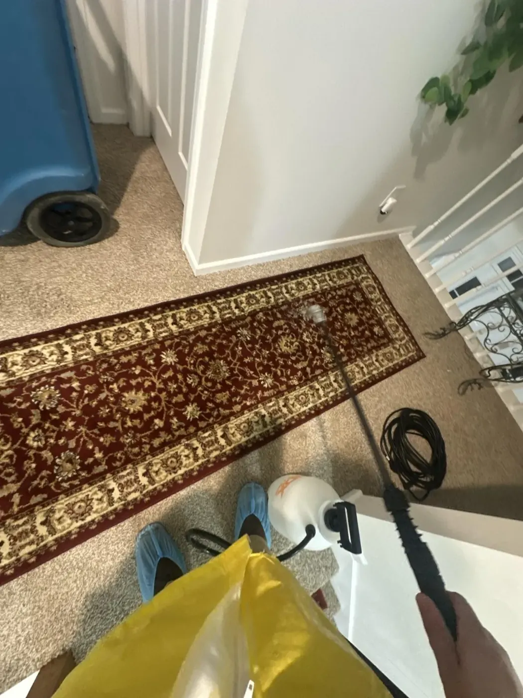 Technician in protective gear fogging a hallway to remove odor in Conyers, GA