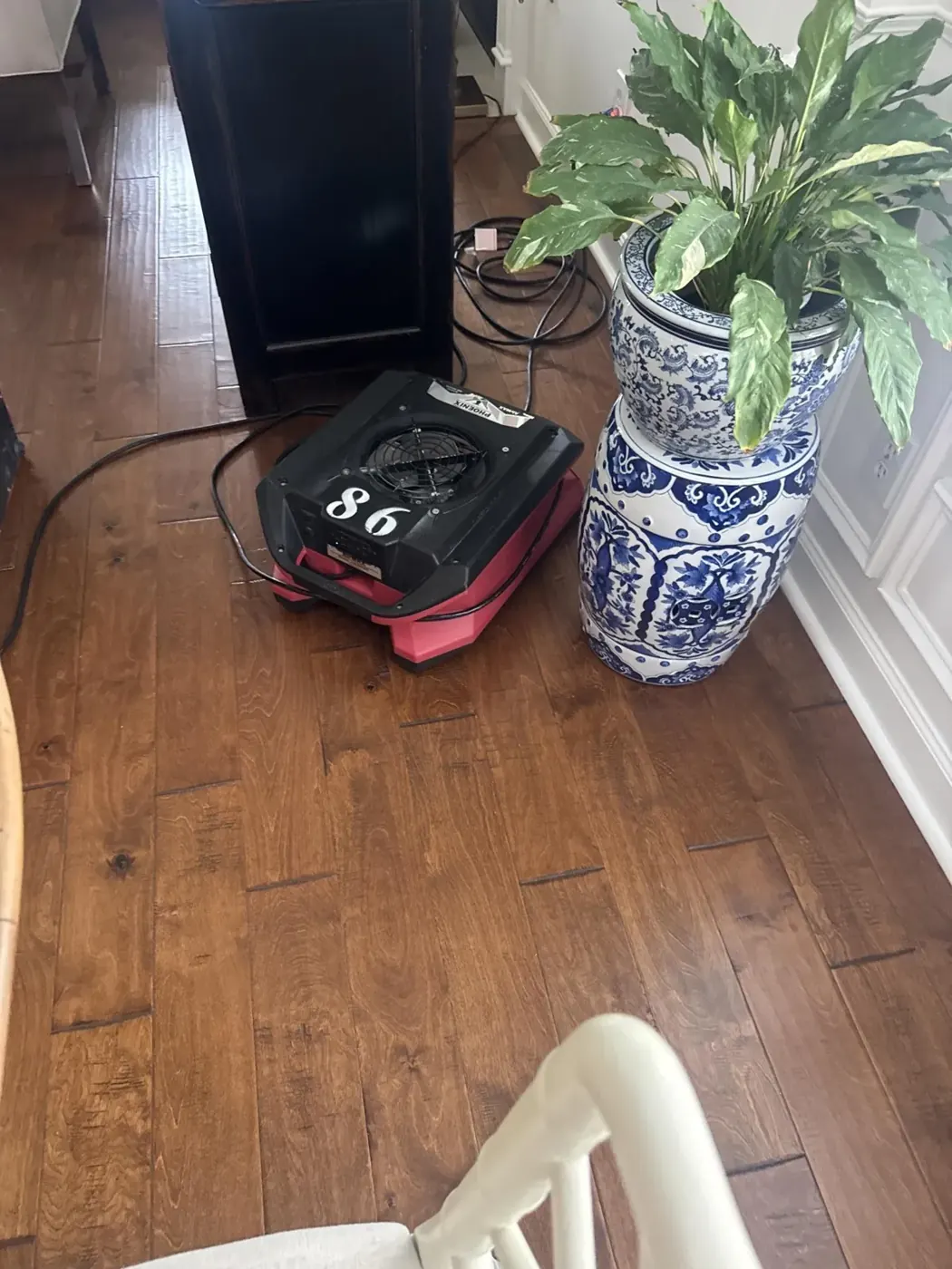Air mover and dehumidifier drying a dining room floor in Suwanee, GA