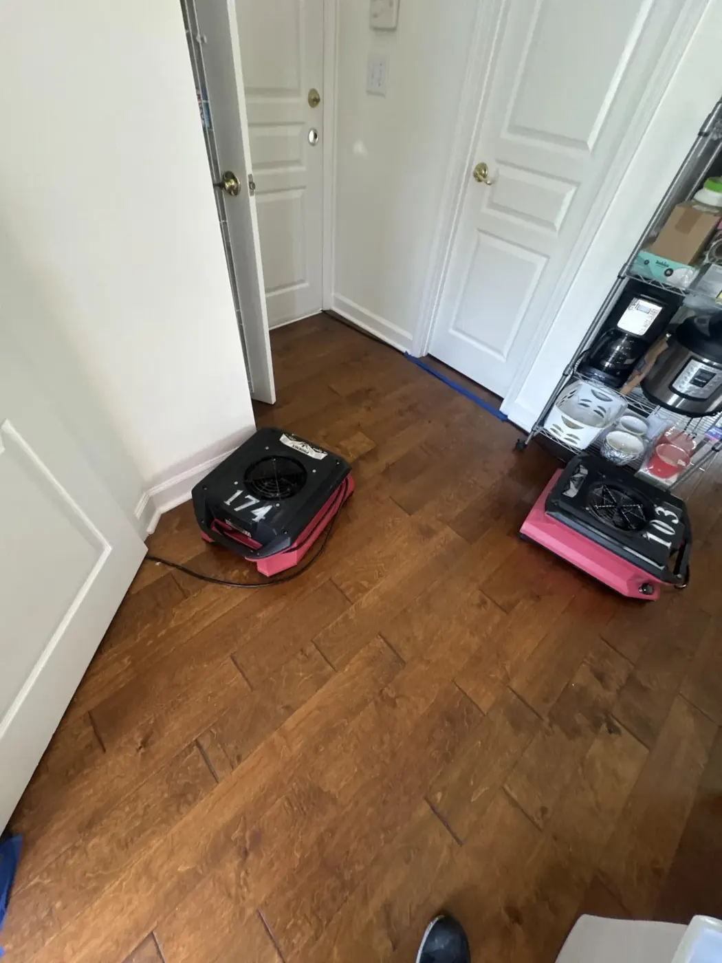 Dehumidifier and air movers drying hardwood floors after a water leak in Suwanee, GA