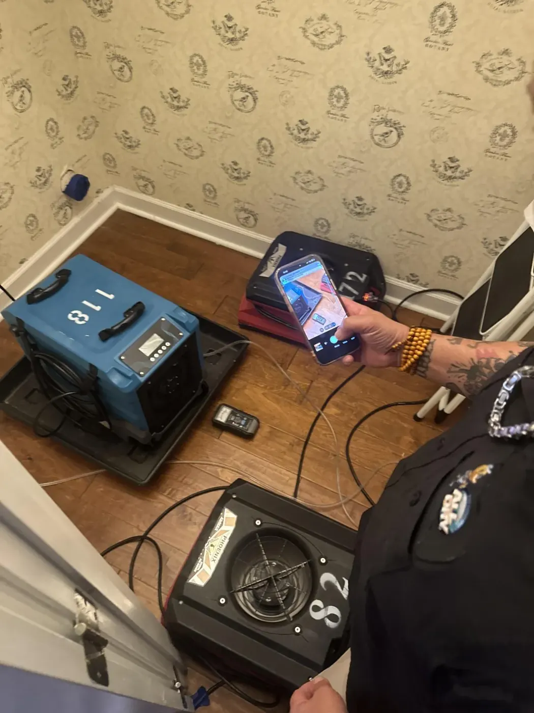 Technician monitoring drying equipment readings in Suwanee, GA
