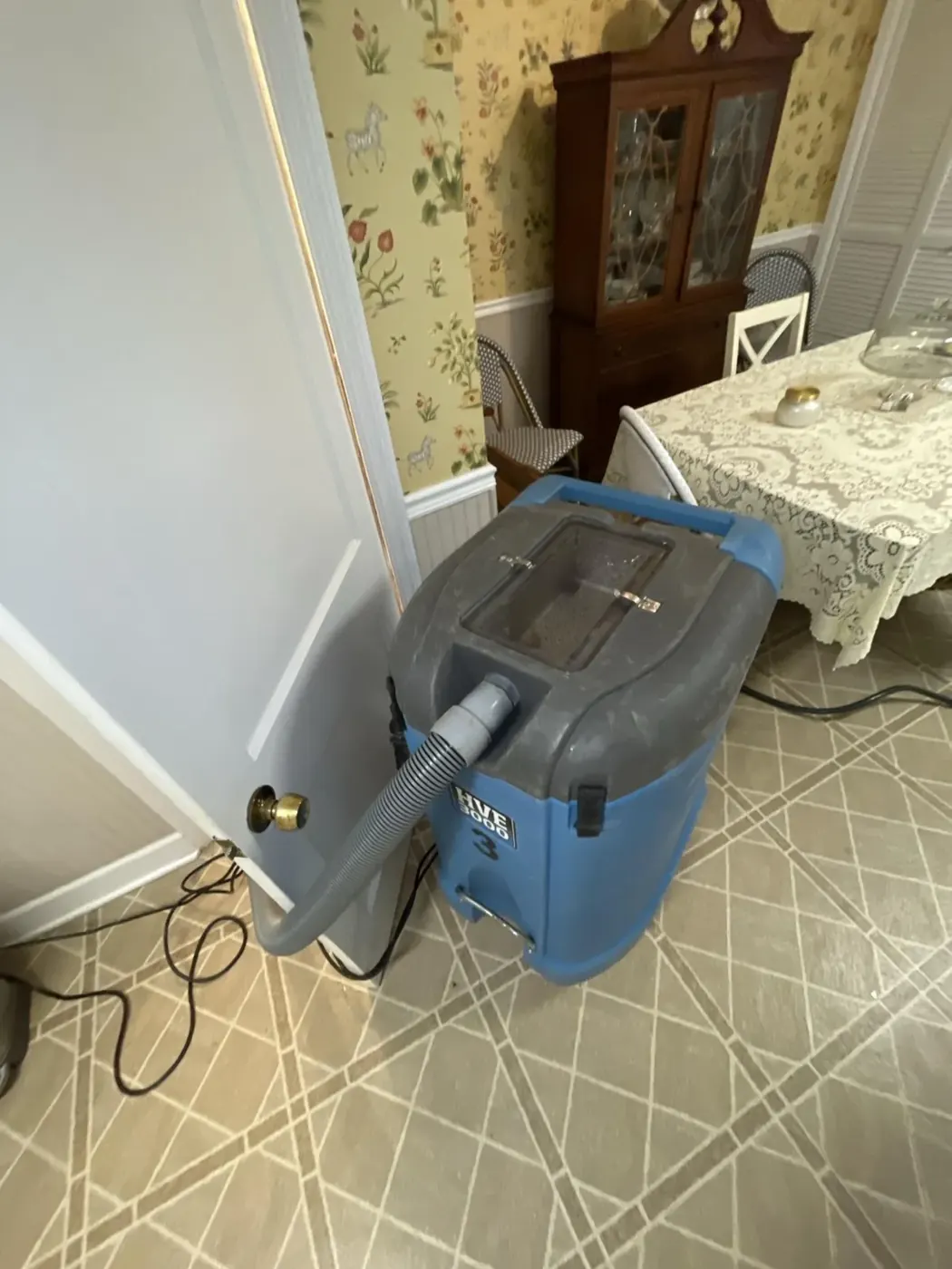Commercial dehumidifier drying a room after a basement flood in Alpharetta, GA