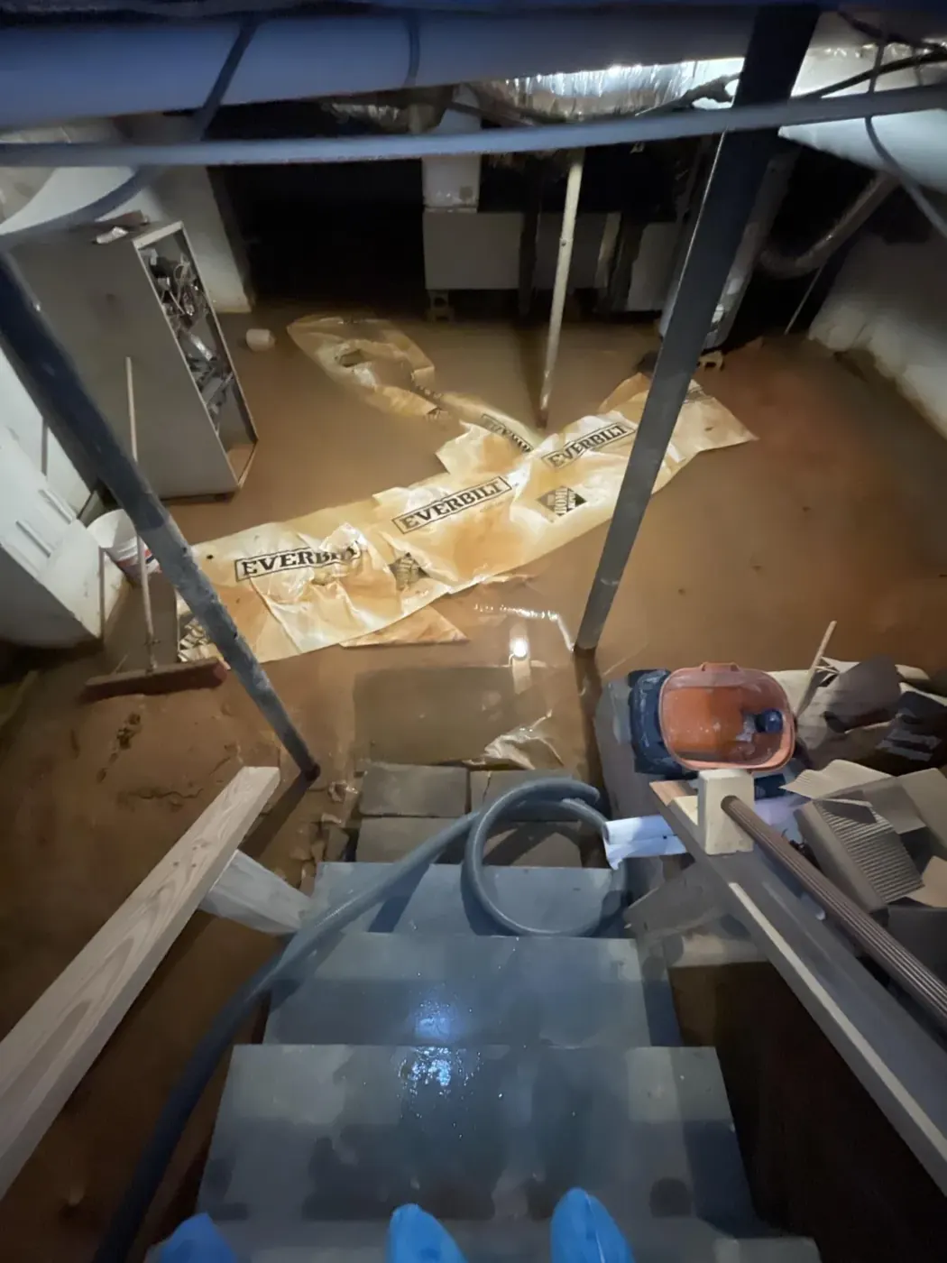 All Dry technician extracting standing water from a flooded basement in Alpharetta, GA