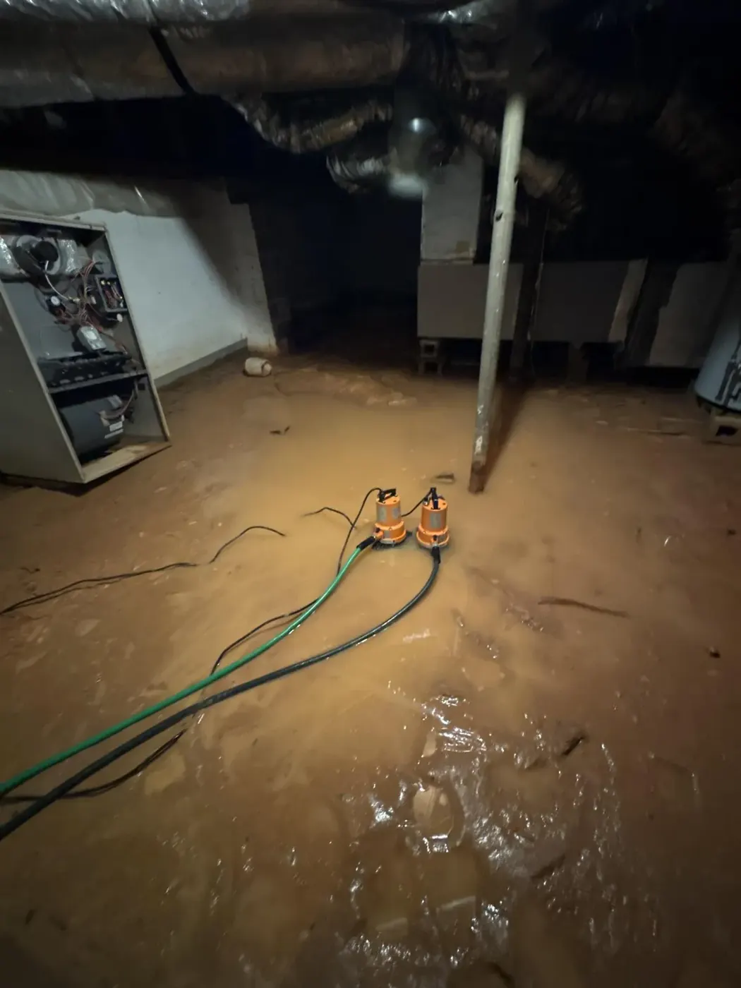 Unfinished basement with standing water before cleanup in Alpharetta, GA