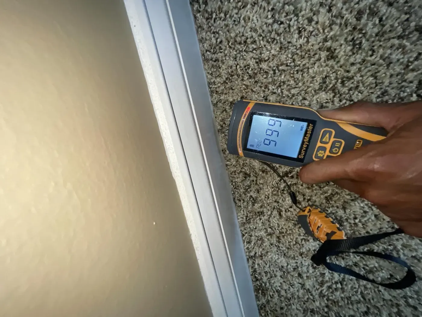 Technician checking a wall with a moisture meter in Marietta, GA