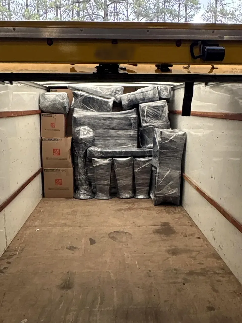 Wrapped household contents loaded for off-site cleaning and storage